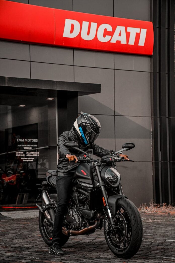 person wearing helmet riding a black motorcycle