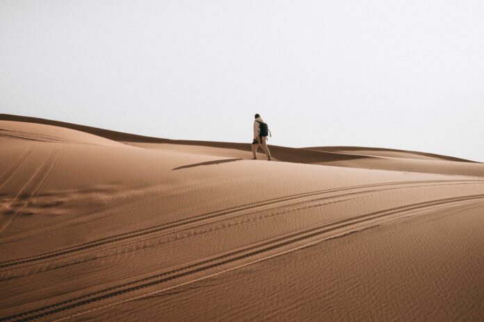 man hiking in desert