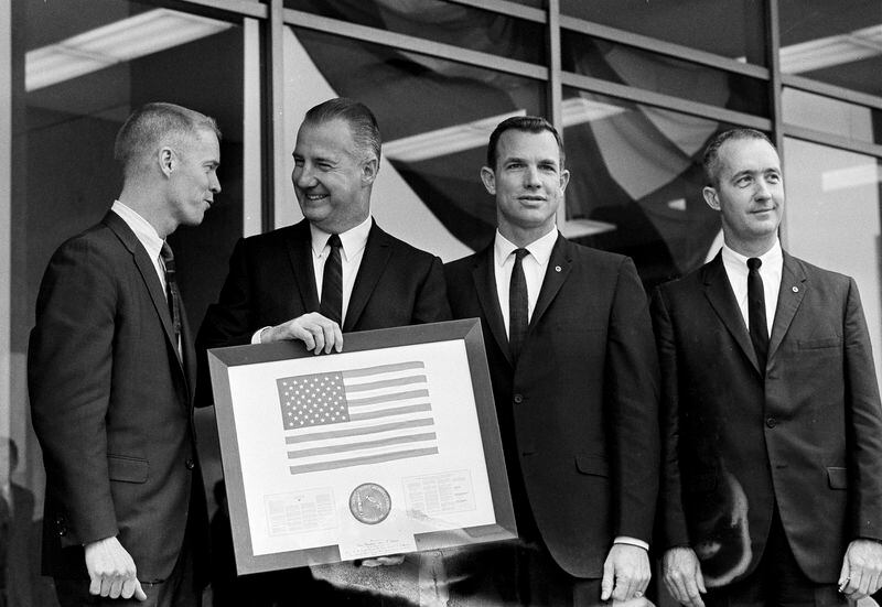 En Washington, DC, el vicepresidente Spiro T. Agnew, segundo desde la izquierda, acepta una bandera estadounidense enmarcada que ondea en el espacio por los astronautas del Apolo 9 Russell L. Schweickart, izquierda, David R. Scott y James A. McDivitt.